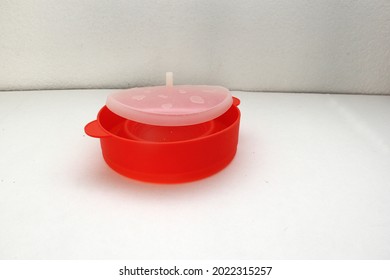 Red Collapsible Microwave Silicone Popcorn Bowl With Fresh Popcorn And Corn All Ready For Movie Watching
