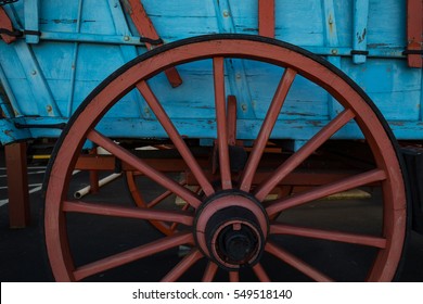 The red color of a Conestoga Wagon wheel against the blue body is disinctive.
