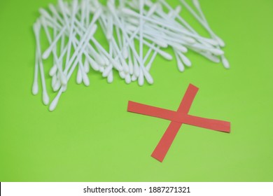 Red Color Cross Drawn In Front Of Cotton Buds To Raise Awareness For Ear Safety 