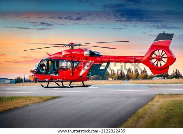 Red color helicopter. Great photo on\
the theme of air medical service, air transportation,  air\
ambulance,  fast city transportation or helicopter tours.\
