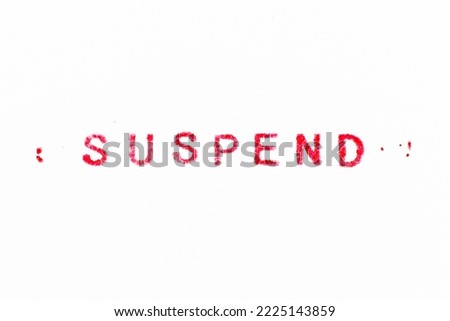 Red color ink rubber stamp in word suspend on white paper background