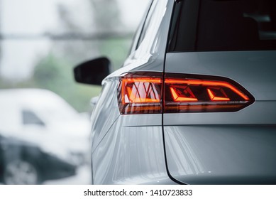 Red color lighting. Particle view of modern luxury white car parked indoors at daytime. - Powered by Shutterstock