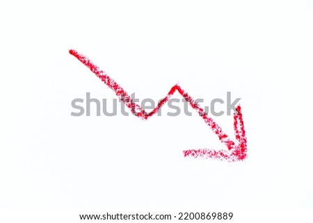 Red color oil pastel hand drawing in downward trend arrow shape on white paper background