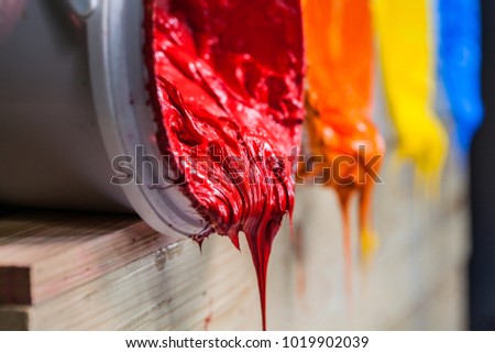 red color of plastisol ink flowed out of the barrel. plastisol ink is specially for print on tee shirts and any fabric. the ink useful in tee shirt factory garment and industry for export
