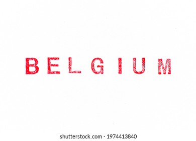 Red color rubber stamp in word belgium on white paper background