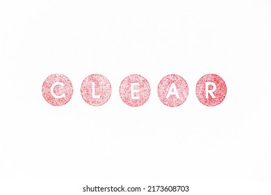 Red color rubber stamp in word clear on white paper background
