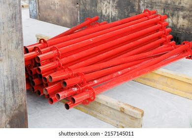 Red color steel props for supporting the formwork lens on wood support beams and ready for install