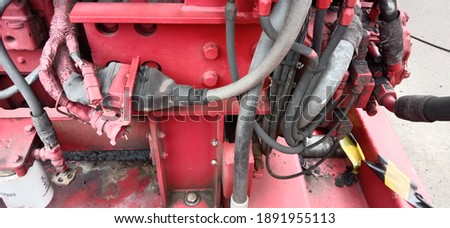 red colored equipment of pipes and cables for machines