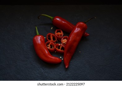 Red coloured large chilli and chilli slices. Spicy, bright red coloured, beautiful chilli. India. Used as spice and make stuffed chilli pickle from these chillies.