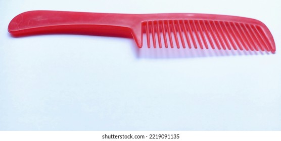 Red Comb On A White Background.