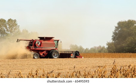 Red Combine Harvesting A Crop Of Soybeans