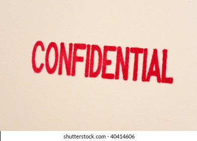 A Red Confidential Stamp On A Manila Folder