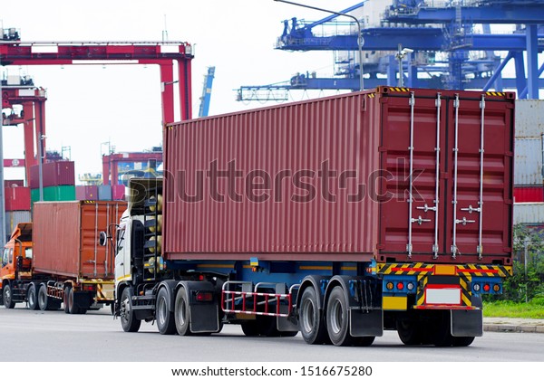 Red Container truck in ship port\
Logistics.Transportation industry in port business\
concept.import,export logistic industrial Transporting Land\
transport on Port transportation storge   \

