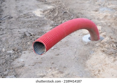 Red Corrugated Pipe Are Buried Underground On Construction Site