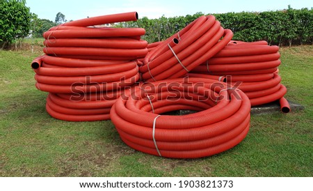 Red corrugated pipe on the street