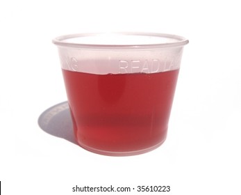 Red Cough Syrup Medicine In Dosage Dispenser Cup