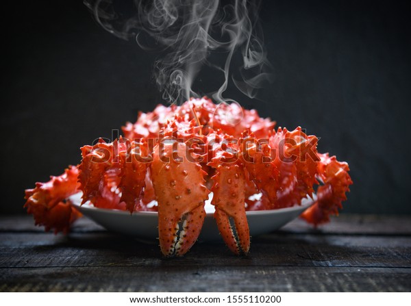 Red crab hokkaido / Alaskan king crab\
cooked steam or boiled seafood on dark\
background