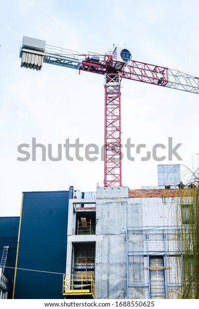 red crane and construction\
site