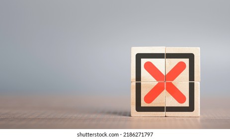 Red Cross mark, x, Wrong mark sign, Rejection sign in wooden cube stack. Concept of negative decision making or choice of vote with copy space for background or text. - Shutterstock ID 2186271797