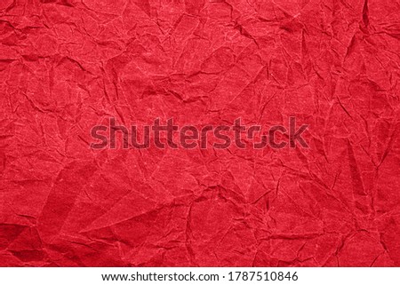 Red crumpled paper texture. Red wrapping paper as Christmas backdrop 