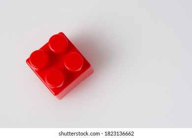 Red cube block constructor on a white background with copy space. Construction idea concept