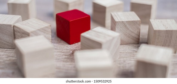 Red cube block different from crowd of wood blocks. Unique Leader, strategy, independence, think different, business and success concept