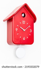 Red cuckoo clock with white pendulum isolated