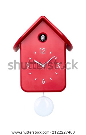 Red cuckoo clock with white pendulum isolated 