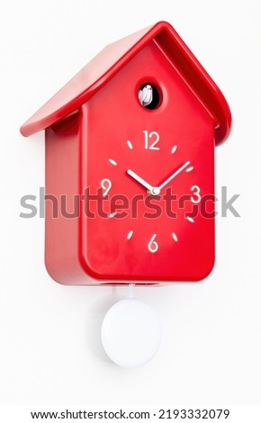 Red cuckoo clock with white pendulum isolated