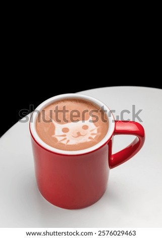 red cup with a hot drink. coffee, latte, cappuccino, cocoa. A drawing of a cat is laid out on the surface of the milk foam drink.  Children's drink. Cafe menu. Copy space