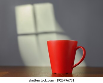 Red Cup On The Table And Light From The Window