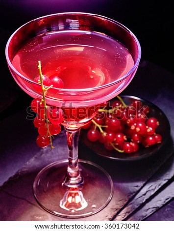 Red currant cocktail  on black background.