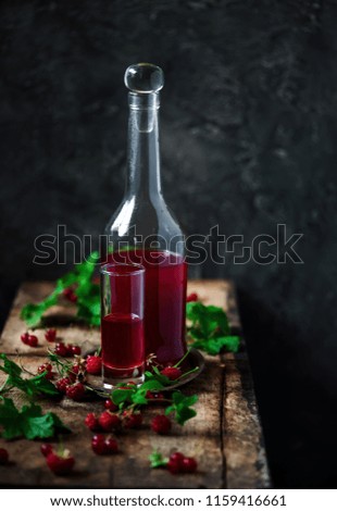 red currant  homemade liquor in the glasses. style vintage. selective focus