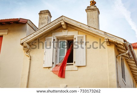 Red curtain outside a window