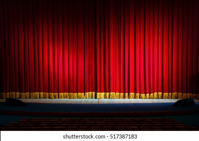 Red Curtains In A Theater Scene Of The Show. Closed Theater Curtain Of Red Velvet, Texture, Background.