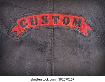 Red Custom Label On Back Of Leather Jacket In Close-up.