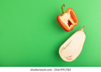 Red Cutted pepper and Purple Cutted eggplant on green pastel background. Top view, flat lay, copy space. Tropical, healthy food, vegetable, slice, minimalism. - Powered by Shutterstock