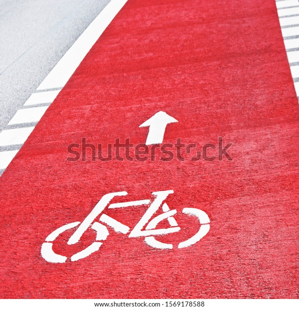 Red\
cycle path with direction arrow background\
close-up