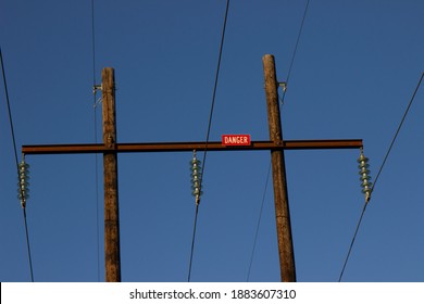 Red Danger Sign On Wooden Power Pole