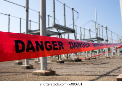 Red Danger Tape Barricade For High Voltage Safety With Switch Yard At The Background