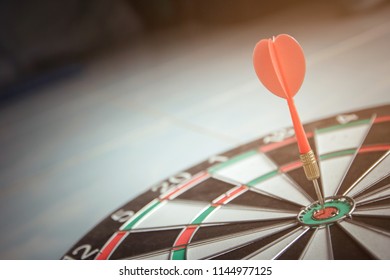red dart arrow hitting on target center  dartboard , business success concept. - Shutterstock ID 1144977125