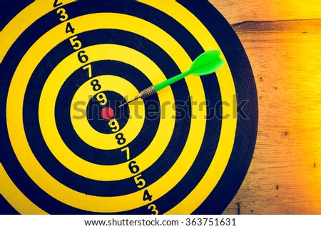 Red dart arrow put on center of dartboard business solution concept - Light leak effect