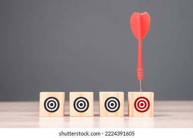 Red dart hit the only wood cube with different red target symbol, narrow the target, target audience, marketing campaign