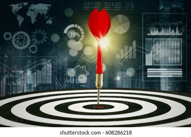 Red Dart Hitting The Bullseye On The Dartboard With Financial Statistics Background. Concept Of Stock Market Target And Financial Graph.