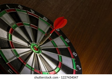 Red Dart hitting center Target, Right on target concept using dart in the bulls eye on dartboard business success concept fierce competition on stillife tone, - Shutterstock ID 1227434047