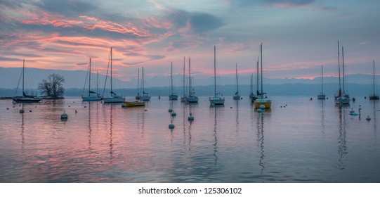 Red Dawn Sunrise And Sailboats At Lake Geneva, Switzerland