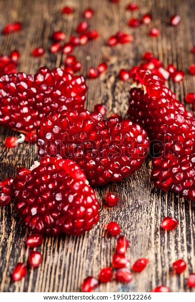 red delicious grains of ripe\
pomegranate, sweet and sour taste of the healthy fruit of the\
pomegranate tree, the fruit is divided into parts with\
seeds