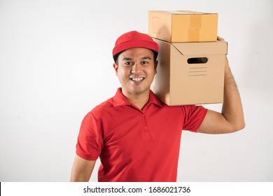 Red Delivery handsome asian man holding parcel cardboard box on isolated white background.