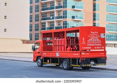 Red Delivery Lorry With Red Gas Cylinders For Home Residential Households. Gas Utility Municipal Service. Truck With Town Gas Barrels.Dubai, UAE, Sept.2022