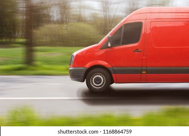 Red Delivery Van On The Road In A Rural Landscape